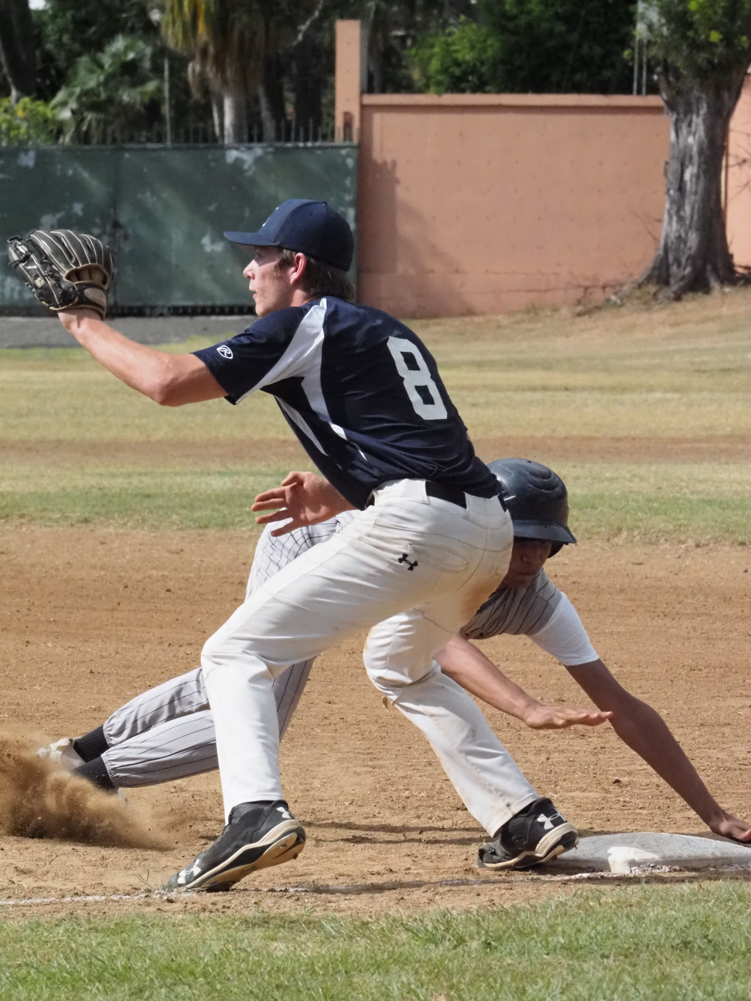 The Hawks rush back to first after attempting to steal for second base.jpg